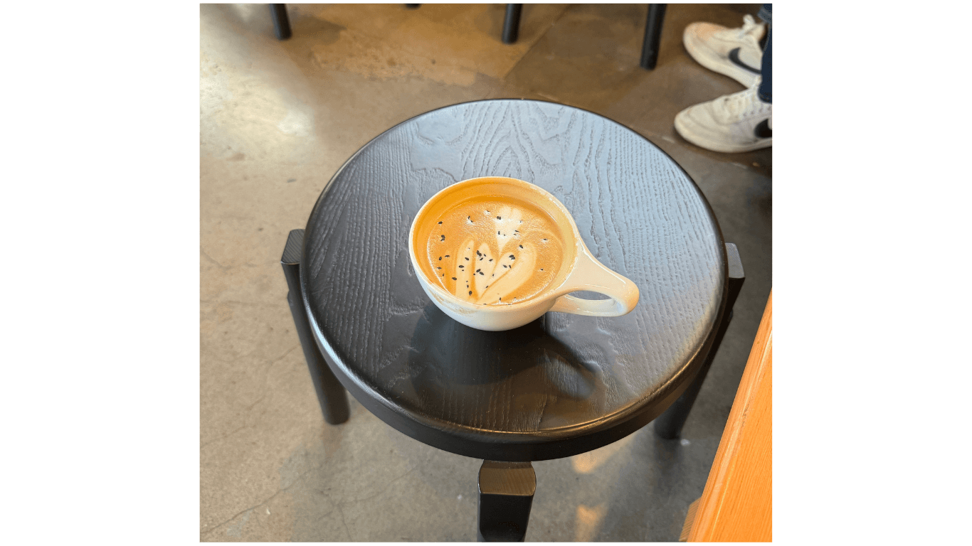 Latte on black table with sip taken out